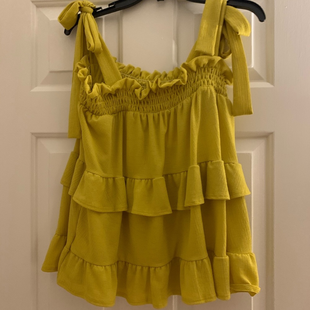 Yellow ruffled tank top.
